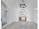 Bright foyer featuring arched doorways, decorative tile, and grand chandelier lighting at 802 S 10Th St, Haines City, FL 33844