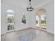 Bright foyer featuring arched doorways, decorative tile, and grand chandelier lighting at 802 S 10Th St, Haines City, FL 33844