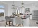 Bright kitchen featuring white cabinets, stainless steel appliances, a large island, and bar stools at 802 S 10Th St, Haines City, FL 33844