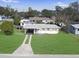 An aerial view of a charming single-story home with a well-manicured lawn and a convenient covered carport at 8101 Dominguin St, Orlando, FL 32817