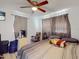 Bedroom with neutral gray and white tones, featuring a ceiling fan and television at 8101 Dominguin St, Orlando, FL 32817