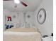 Bedroom featuring a bed with a beige blanket, white curtains, and decorative wall art at 8101 Dominguin St, Orlando, FL 32817