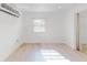 Bright bedroom with hardwood floors, mini-split AC, and a window at 8101 Dominguin St, Orlando, FL 32817