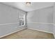 Empty bedroom featuring neutral walls, carpeting, and a window to let in natural light at 8103 Yellow Crane Dr, Kissimmee, FL 34747