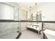 Elegant bathroom features a glass shower, soaking tub, and vanity with dual sinks at 8766 The Esplanade # 23, Orlando, FL 32836