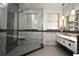 Modern bathroom with a glass shower, dual sinks, and stylish fixtures at 8766 The Esplanade # 23, Orlando, FL 32836