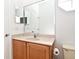 Functional bathroom features a vanity with a sink, toilet, and large mirror at 8766 The Esplanade # 23, Orlando, FL 32836