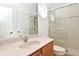 Clean bathroom featuring a shower with sliding glass door, vanity with sink, and a toilet at 8766 The Esplanade # 23, Orlando, FL 32836