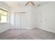 Bright bedroom featuring a ceiling fan, neutral paint, carpet, and a window with natural light at 8766 The Esplanade # 23, Orlando, FL 32836