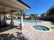 View of the community pool, hot tub, and covered patio area with ceiling fan at 8766 The Esplanade # 23, Orlando, FL 32836