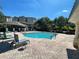 Community pool with lounge chairs and tables; apartment buildings in the background at 8766 The Esplanade # 23, Orlando, FL 32836