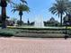 Community fountain with water feature, surrounded by lush landscaping and palm trees at 8766 The Esplanade # 23, Orlando, FL 32836