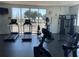 Gym with treadmills, elliptical, rowing machine, weight machine, and large windows at 8766 The Esplanade # 23, Orlando, FL 32836