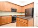 Well-appointed kitchen with stainless steel appliances, center island, and wood cabinetry at 8766 The Esplanade # 23, Orlando, FL 32836