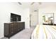 Well-lit main bedroom featuring a television, closet, and king bed at 8766 The Esplanade # 23, Orlando, FL 32836