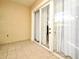 Tiled screened-in patio features sliding glass doors and neutral paint at 8766 The Esplanade # 23, Orlando, FL 32836