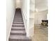 Carpeted staircase leading to an open living area with built-in shelves at 8766 The Esplanade # 23, Orlando, FL 32836