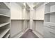 Spacious walk-in closet features custom shelving and ample storage space for organization and convenience at 8766 The Esplanade # 23, Orlando, FL 32836