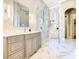 This bright bathroom features marble countertops, a glass shower, and modern fixtures at 885 Spring Park Loop, Celebration, FL 34747