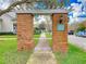 Spring Park Reserve brick entrance with pergola leading to sidewalk lined with trees at 885 Spring Park Loop, Celebration, FL 34747