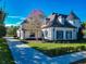 Stately two-story home featuring manicured landscaping, a turret, and a circular driveway at 885 Spring Park Loop, Celebration, FL 34747