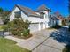 Grand two-story home with three-car garage and well-maintained front yard at 885 Spring Park Loop, Celebration, FL 34747