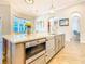 Kitchen island featuring stainless steel appliances and sink, with hardwood flooring at 885 Spring Park Loop, Celebration, FL 34747