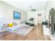 Bright living room featuring hardwood floors, plush rug, and modern decor with a treadmill for exercise at 885 Spring Park Loop, Celebration, FL 34747