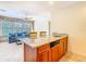 Bright living room featuring a wet bar, comfortable blue sofa, and large windows letting in natural light at 885 Spring Park Loop, Celebration, FL 34747