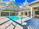 Beautiful screened-in pool area with brick pavers and ample seating at 885 Spring Park Loop, Celebration, FL 34747