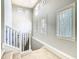 Bright stairwell with multiple windows providing natural light and elegant iron railing at 885 Spring Park Loop, Celebration, FL 34747