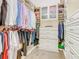 This tidy walk-in closet has built-in shelving, drawers, and rods for clothing, shoes, and accessories at 885 Spring Park Loop, Celebration, FL 34747