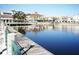 Scenic waterfront view with a boardwalk in front of commercial buildings reflected in the calm water on a clear day at 885 Spring Park Loop, Celebration, FL 34747