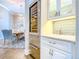 View of custom wet bar with stainless steel wine cooler and marble countertops at 885 Spring Park Loop, Celebration, FL 34747