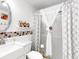 Cozy bathroom features patterned shower curtains, mosaic tiles, and decorative shelving at 901 W Donegan Ave, Kissimmee, FL 34741