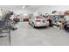 Wide angle shot of a garage featuring tables, chairs, appliances, and a vehicle at 901 W Donegan Ave, Kissimmee, FL 34741