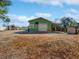 This outbuilding features a covered parking area, garage door, and potential workshop space at 901 W Donegan Ave, Kissimmee, FL 34741