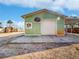 This outbuilding features a garage door, a basketball net and covered parking at 901 W Donegan Ave, Kissimmee, FL 34741