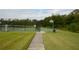 View of the fenced-in community basketball court on a sunny day, perfect for outdoor recreation and neighborhood fun at 991 Lake Berkley Dr, Kissimmee, FL 34746