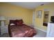 Comfortable bedroom features a queen-size bed, a nightstand, and a mirror at 991 Lake Berkley Dr, Kissimmee, FL 34746