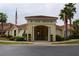 Charming community clubhouse with inviting entrance, classic architectural details, and lush landscaping at 991 Lake Berkley Dr, Kissimmee, FL 34746