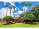 Beautifully landscaped entrance to Lake Berkley Resort with palm trees and colorful foliage at 991 Lake Berkley Dr, Kissimmee, FL 34746