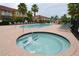 Relaxing community hot tub and swimming pool with comfortable lounge chairs and nearby lush tropical landscaping at 991 Lake Berkley Dr, Kissimmee, FL 34746