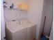 Laundry room featuring a washer, a dryer, and shelving at 991 Lake Berkley Dr, Kissimmee, FL 34746