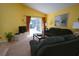 Bright living room with vaulted ceiling, sliding glass doors, plush seating, and neutral carpet at 991 Lake Berkley Dr, Kissimmee, FL 34746