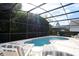 Relaxing screened-in pool area, perfect for enjoying the outdoors and soaking up the sun at 991 Lake Berkley Dr, Kissimmee, FL 34746