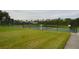 Tennis court in the Lake Berkley community, surrounded by lush greenery and trees at 991 Lake Berkley Dr, Kissimmee, FL 34746