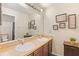 Neutral bathroom showcasing a double sink vanity with framed art pieces on the wall at 1894 Valley Forge Dr, St Cloud, FL 34769