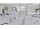 A luxurious bathroom with dual sinks, a soaking tub, and modern fixtures and subway tile backsplash at 1894 Valley Forge Dr, St Cloud, FL 34769