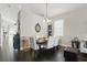 Cozy dining area with a chandelier, seating for six, and dark hardwood floors for gatherings at 1894 Valley Forge Dr, St Cloud, FL 34769